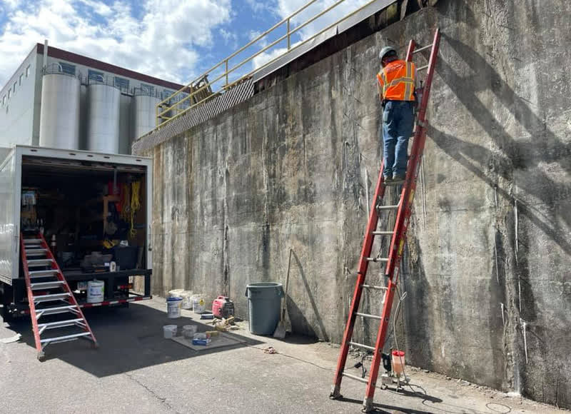Adoration contractor working on concrete wall repair in the US